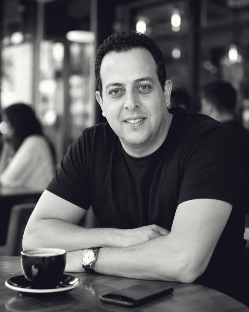 Mohamed B. Kumiha seated at a cafe table