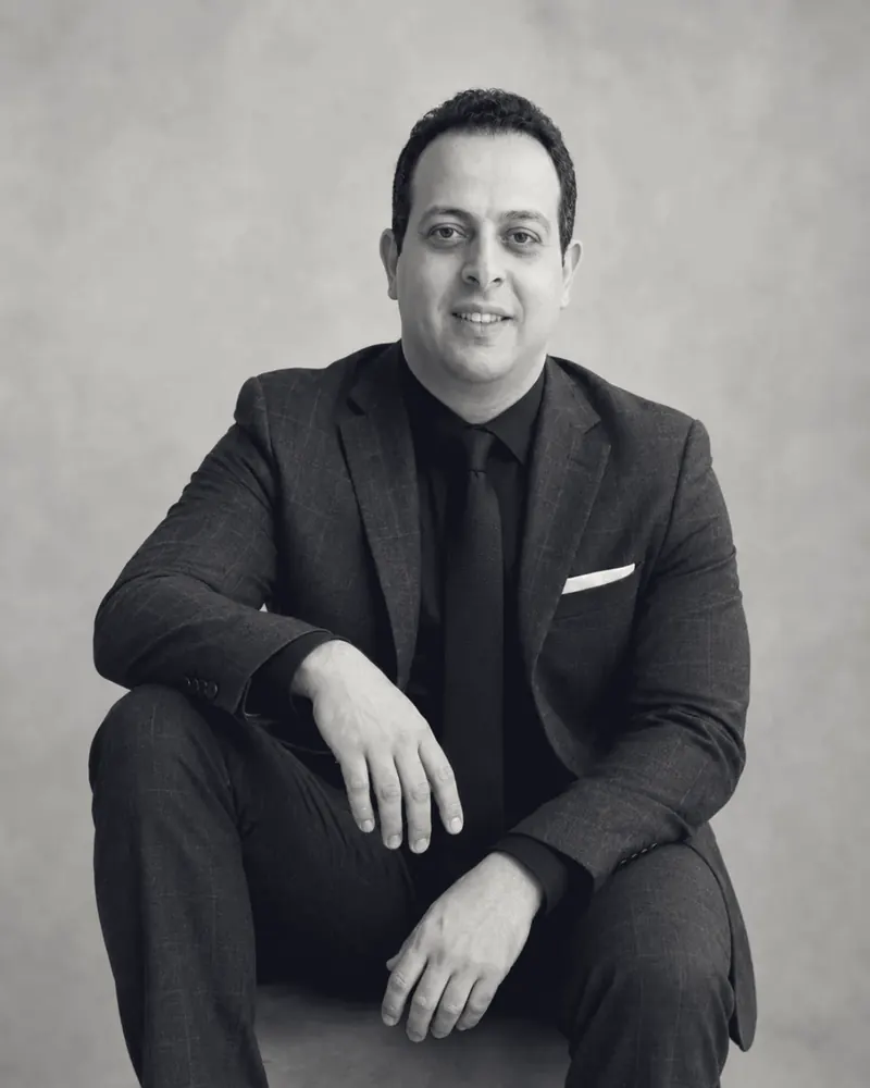 Mohamed B. Kumiha seated in a suit