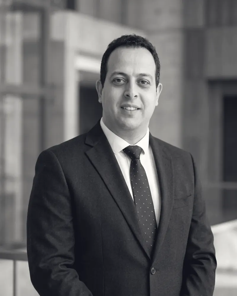 Mohamed B. Kumiha in a suit and tie