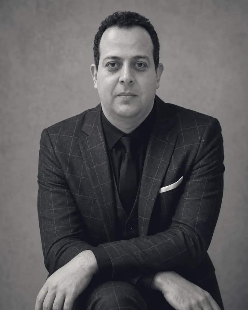Mohamed B. Kumiha seated in a dark suit